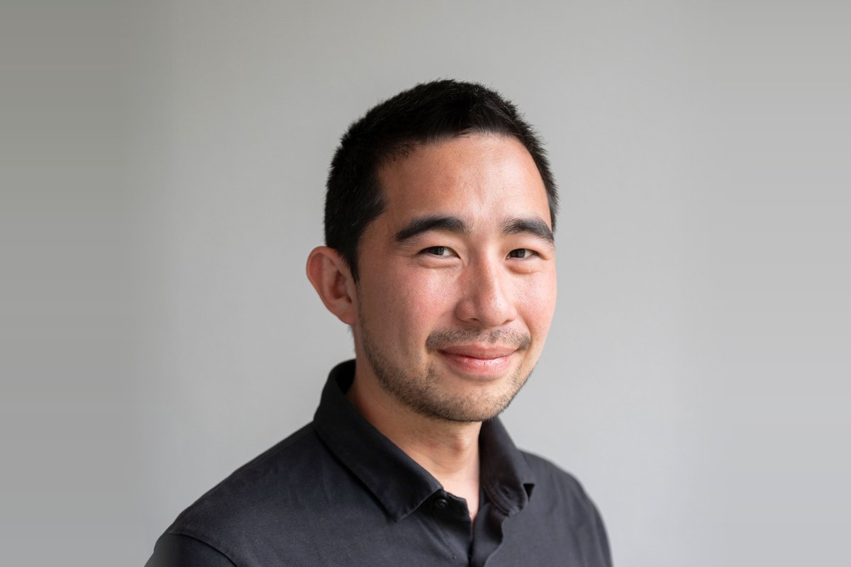 Portrait of Dr. Joaquin Vicente Ferrer, CEO of Repath, smiling in a dark shirt against a grey wall
