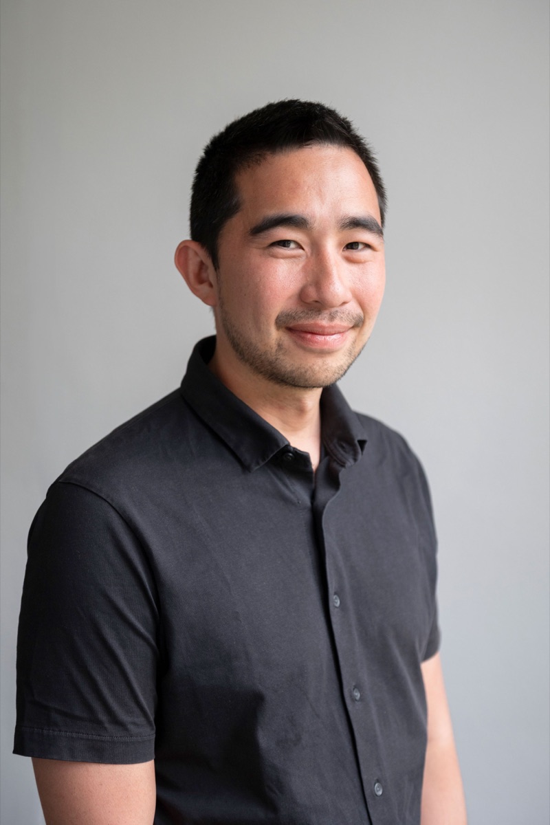 Portrait of Dr. Joaquin Vicente Ferrer, CEO of Repath, smiling in a dark shirt against a grey wall